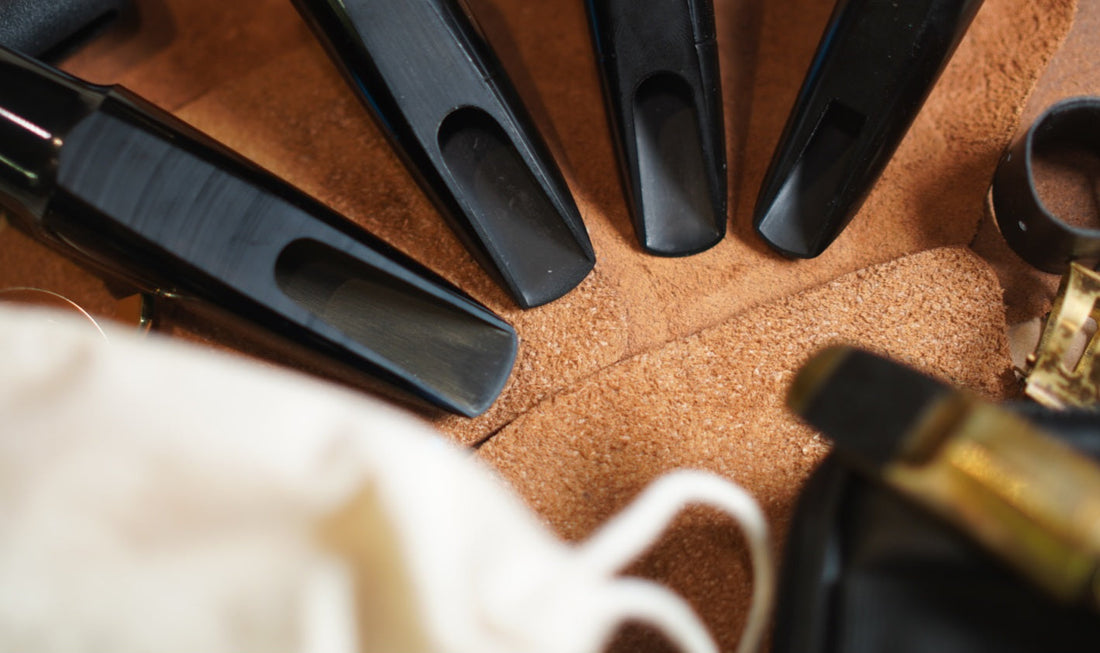 Several mouthpieces in a semi-circle shown on a brown leather background