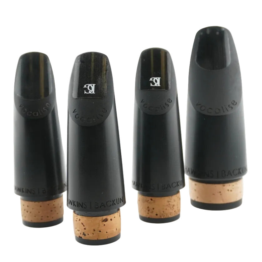 Four black clarinet mouthpieces on a white background