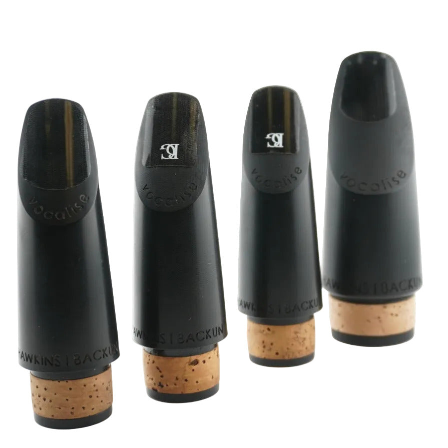 Four black clarinet mouthpieces on a white background