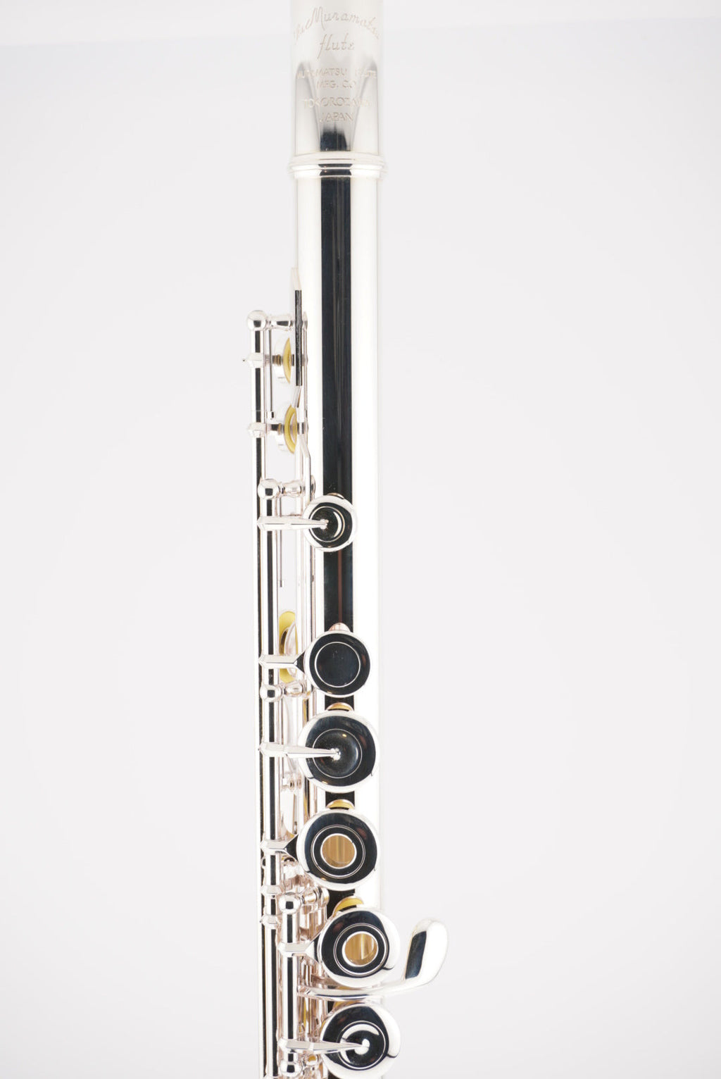 Close-up of a muramatsu flute on a white background