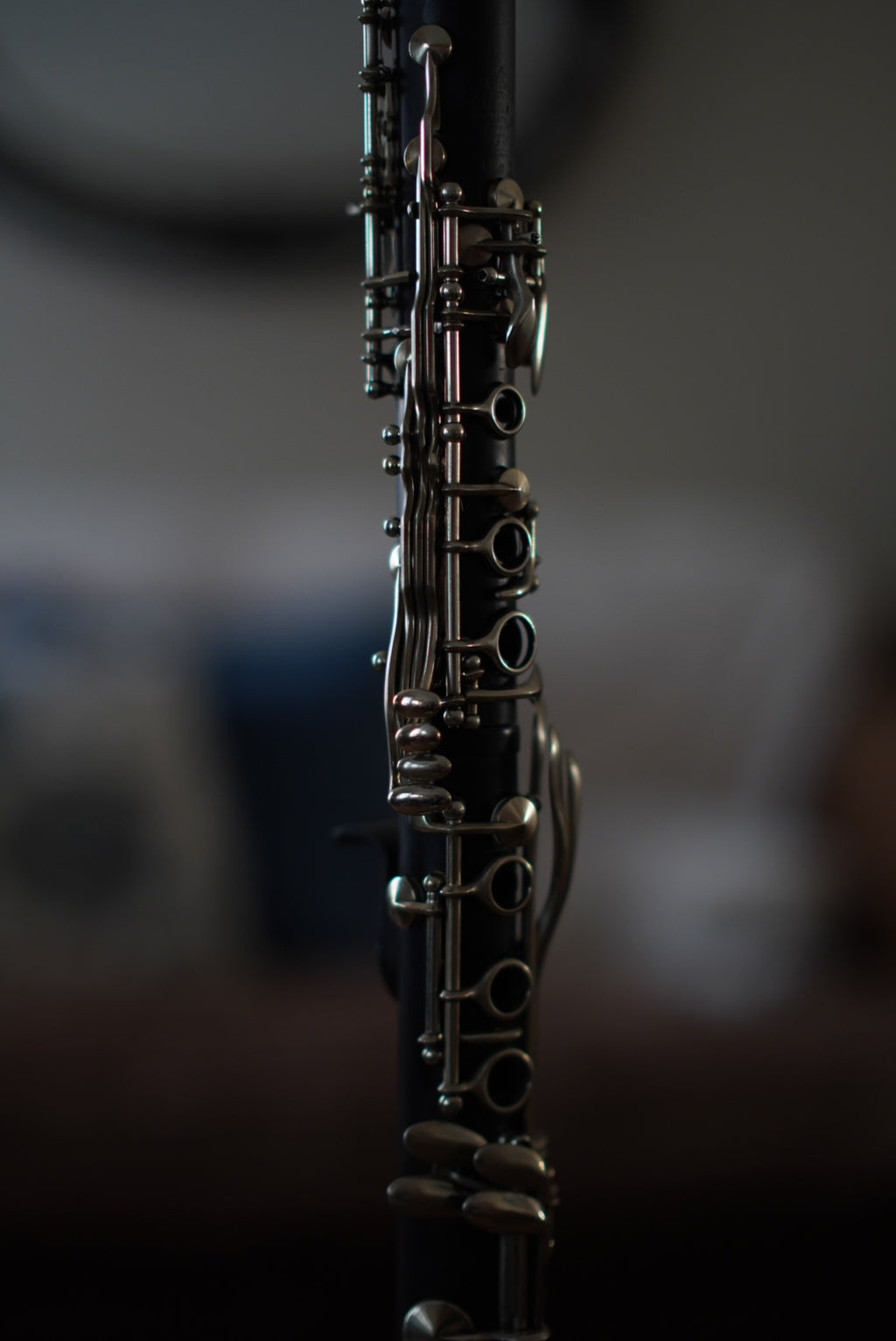 G Leblanc Vintage Clarinet on a stand with a blurred background