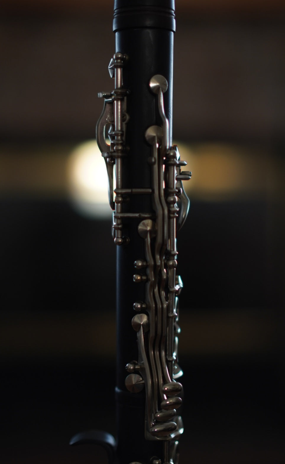 G Leblanc Vintage Clarinet on a stand with a blurred background